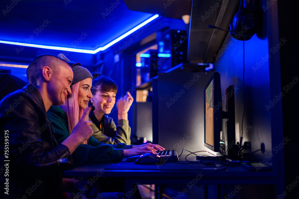 Side view portrait of a woman team of gamers playing online video games