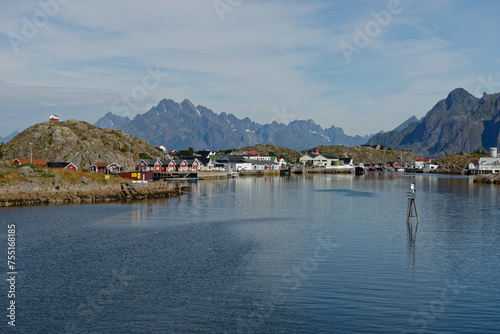 View of fishing village with magnificent mountain range in the background