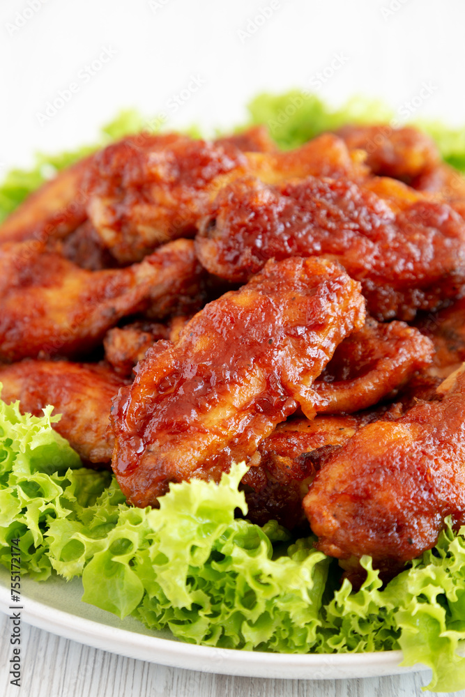 Homemade Honey BBQ Chicken Wings on a Plate, side view. Close-up. Homemade Honey BBQ Chicken Wings on a Plate, side view. Close-up.