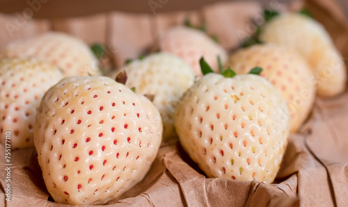 A punnet of white pearl strawberries
