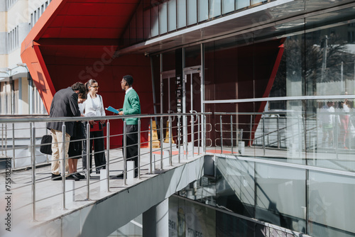 Obraz na plátně A group of professionals convene outdoors for a business meeting in a city environment on a bright day