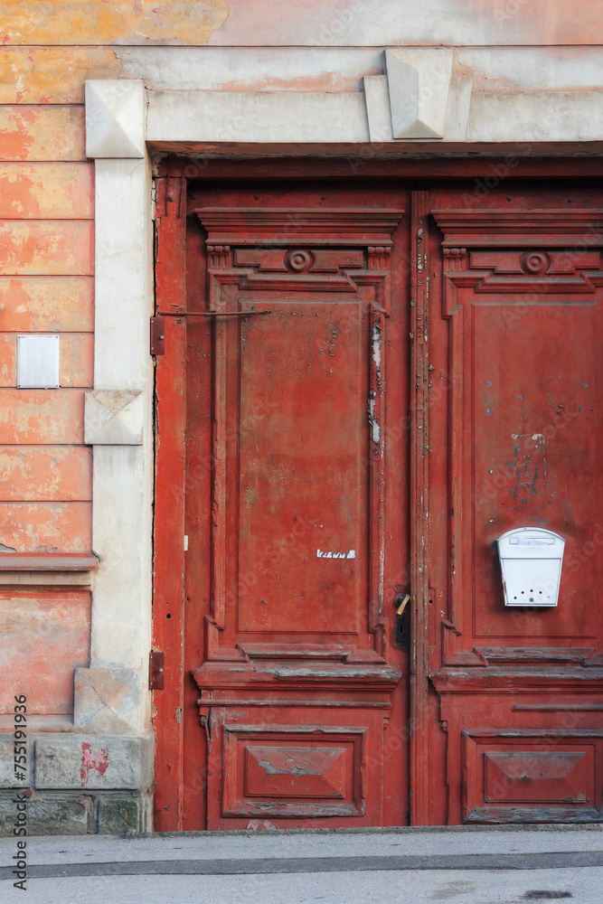 old wooden door on the vintage facade. architectural element
