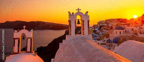 Beautiful sunset with famous Orthodox church on Santorini island, Aegean sea, Greece.