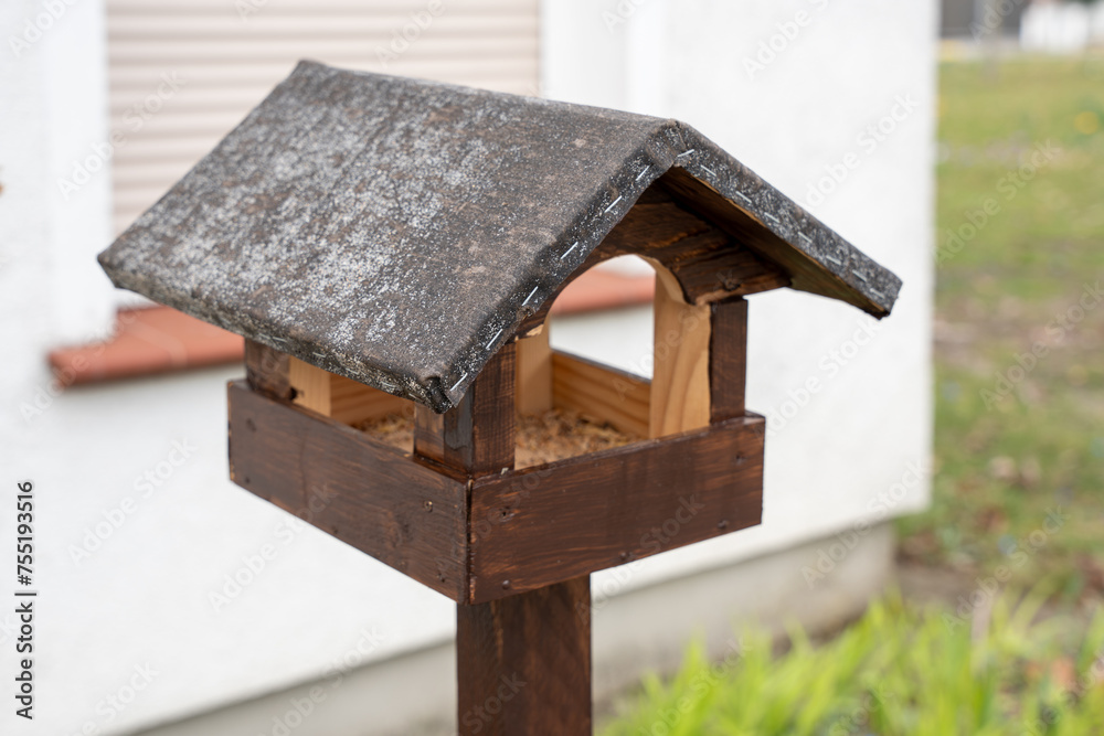 Wooden bird feeder. Bird feeder close up. Wooden bird feeder. Bird feeder close up.