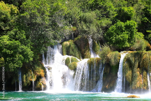 cascade waterfall among large stones in Krka Landscape Park  Croatia in spring or summer. The big beautiful Croatian waterfalls  mountains and nature.