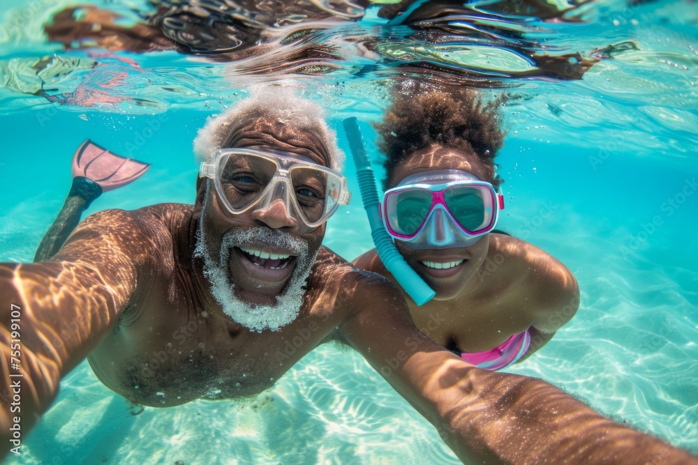 A senior man and woman beam into the camera for a selfie, celebrating their snorkeling adventure in sun-drenched tropical waters.