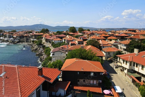 Historic old houses with red tiled roofs, architecture on Black Sea coast. Old town of Nessebar, Bulgaria, Panorama. Beautiful and colorful amazing city, view from above