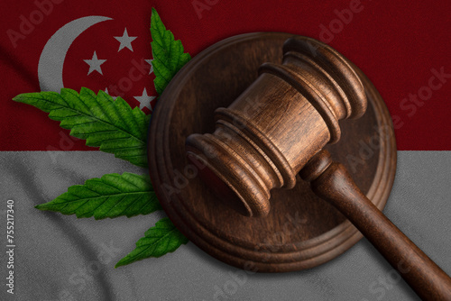 Judges gavel and marijuana leaf on the Singapore flag background. Concept of legalization of marijuana