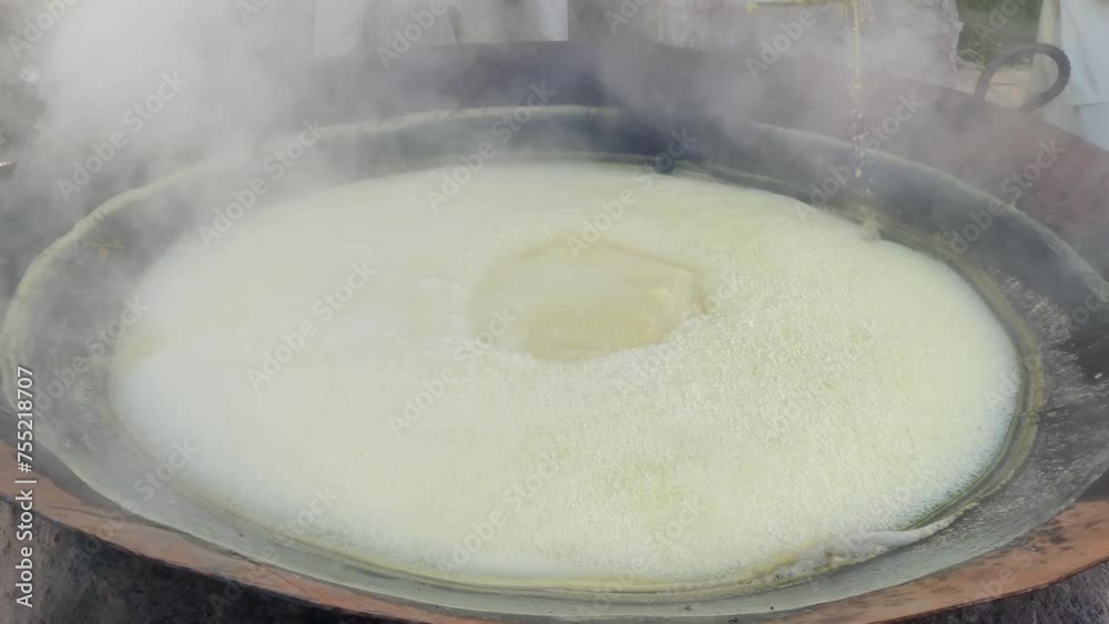 Traditional Jaggery Production: Sugarcane Juice Boiling in Pan Traditional Jaggery Production: Sugarcane Juice Boiling in Pan