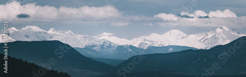 Panoramic photograph of the Pyrenees in winter. Snow-capped peaks with clouds on the horizon. View of the mountain range from Navarra, Spain. Roncal Valley. © JMGarcestock