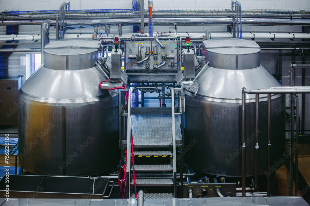 Modern cheese factory, stainless steel milk processing tanks Modern cheese factory, stainless steel milk processing tanks