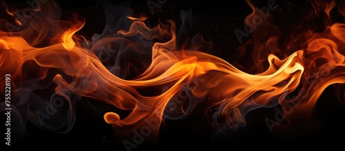 Fire flames are seen burning fiercely against a stark black background, emitting a bright and intense glow. The flames flicker and dance in intricate patterns, showcasing their raw power and energy.