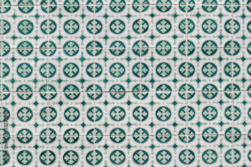Closeup of decorative floral tiles. Traditional Portuguese ceramic tile pattern, azulejos. Clover. Irish green color. Beautiful facade, wall decoration of old Lisbon building. Portugal. Background.