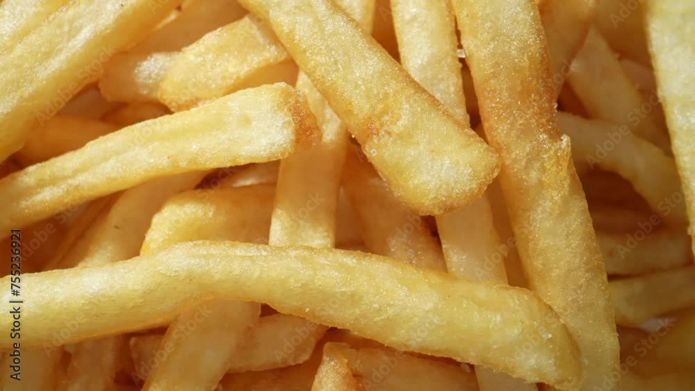 French fries, a beloved snack worldwide, consist of thinly cut potatoes deep-fried until crispy and golden brown. Becoming a staple in fast food menus and home kitchens worldwide. Food concept. 4K.
French fries, a beloved snack worldwide, consist of thinly cut potatoes deep-fried until crispy and golden brown. Becoming a staple in fast food menus and home kitchens worldwide. Food concept. 4K.
