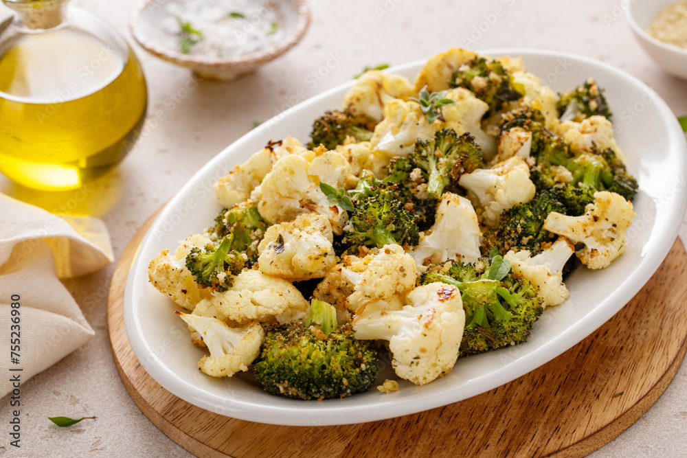 Roasted cauliflower and broccoli on a serving plate, healthy vegetable side dish Roasted cauliflower and broccoli on a serving plate, healthy vegetable side dish