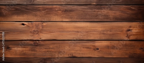 A wooden wall featuring brown stained boards set against a textured wooden background. The stain adds a rich hue to the natural wood, creating a warm and rustic aesthetic.