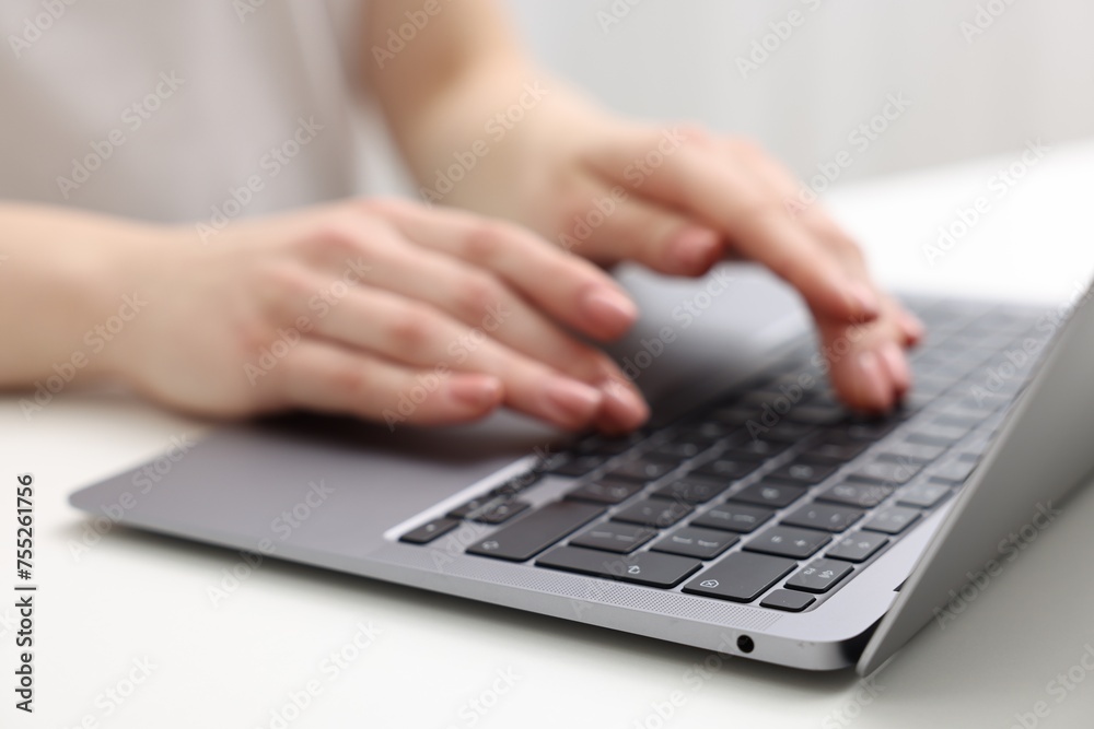 E-learning. Woman using laptop at white table indoors, closeup E-learning. Woman using laptop at white table indoors, closeup