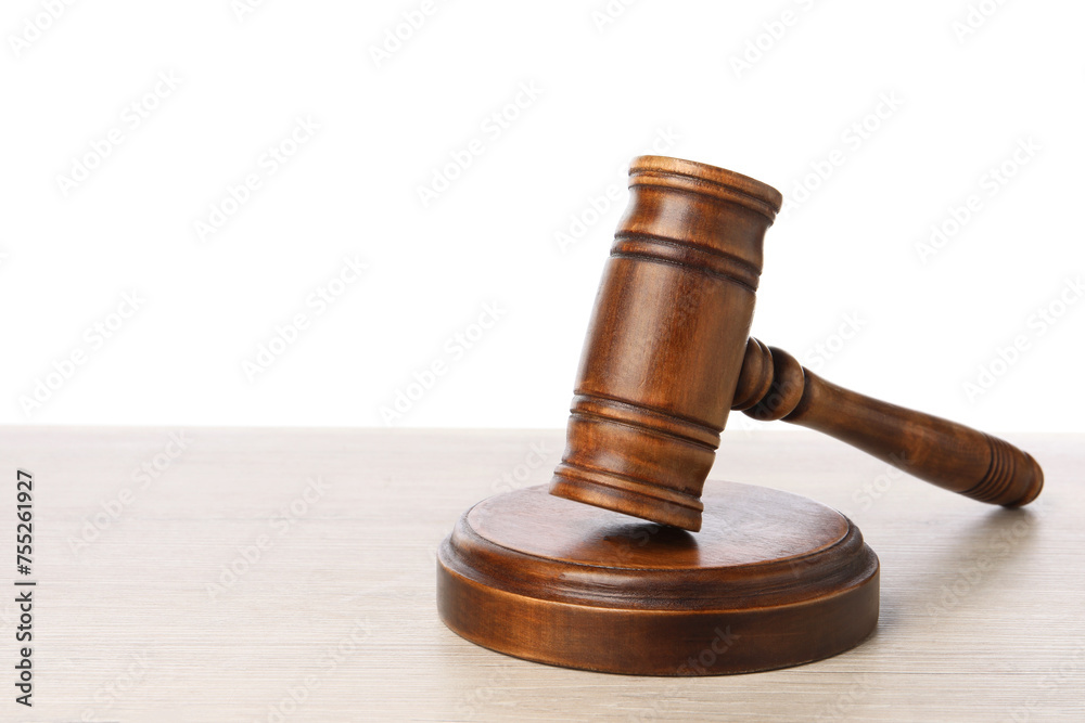 Wooden gavel on light table against white background. Space for text