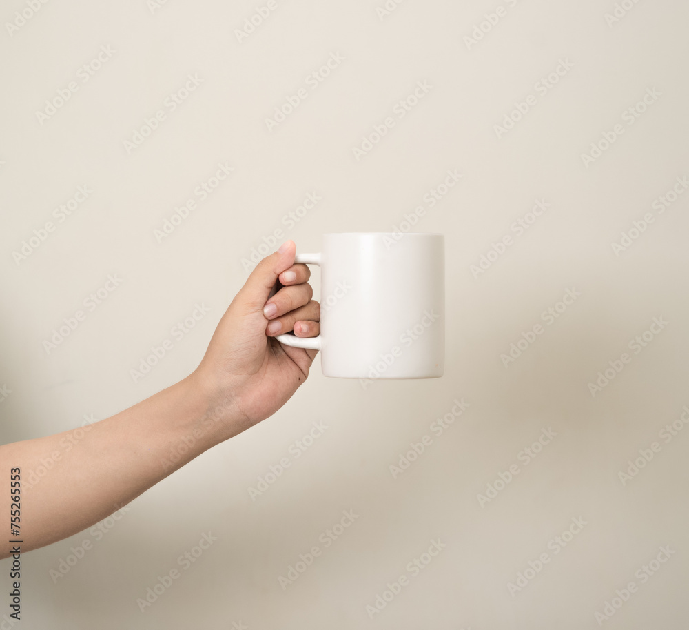hand is holding a mug or glass on a white isolated background hand is holding a mug or glass on a white isolated background