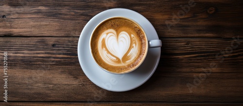 A beautifully crafted cup of cappuccino with heartshaped latte art sits on a rustic wooden table, showcasing the perfect blend of coffee and artistry