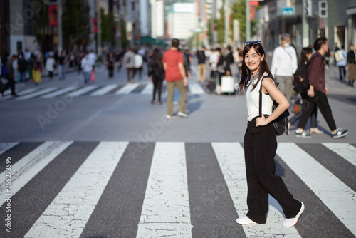 Tokyo's heartbeat, Unseen individuals in the crosswalk, a visual symphony of business and urban lifestyle.