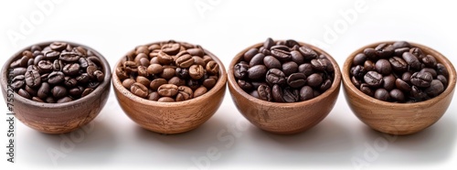 Four wooden bowls lined up with a selection of roasted coffee beans isolated on a white background.