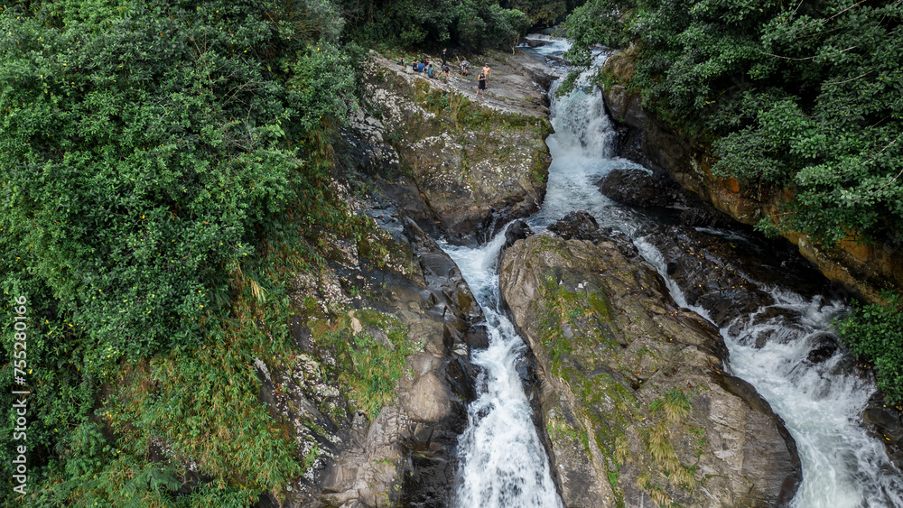 landscape of a huge waterfall in the middle of the jungle of Costa Rica surrounded by vegetation in the Barbilla National Park in indigenous territory landscape of a huge waterfall in the middle of the jungle of Costa Rica surrounded by vegetation in the Barbilla National Park in indigenous territory