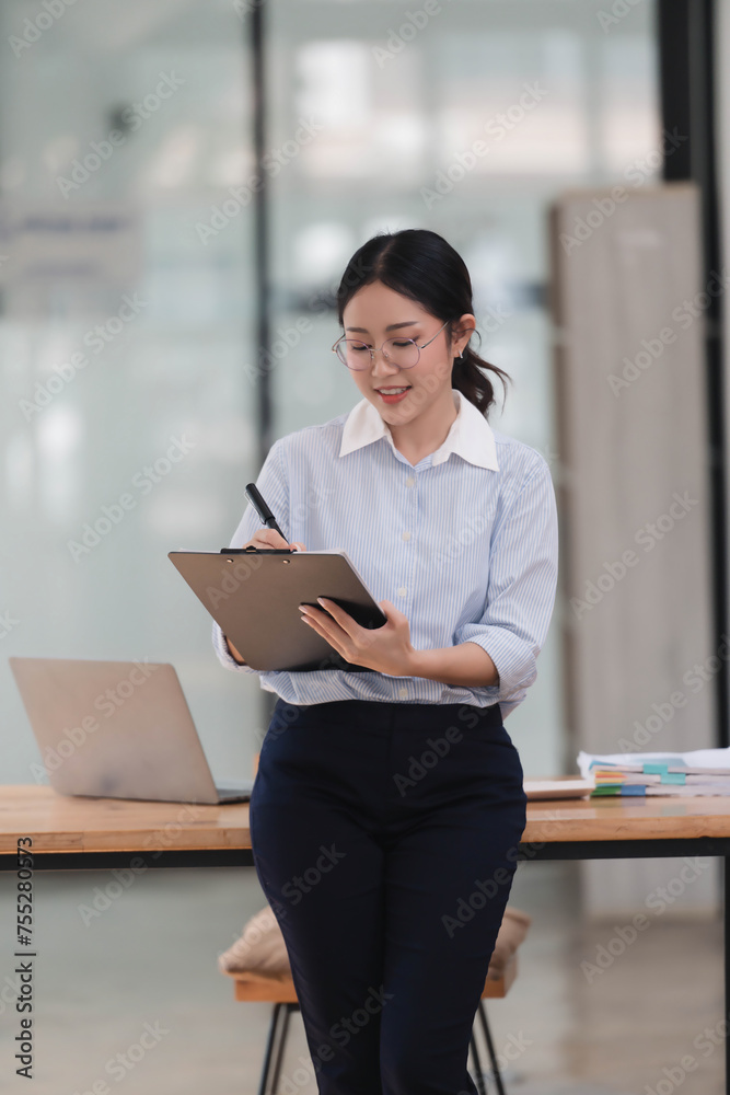 Successful young businesswoman working in her office room, prearing the meeting. Successful young businesswoman working in her office room, prearing the meeting.