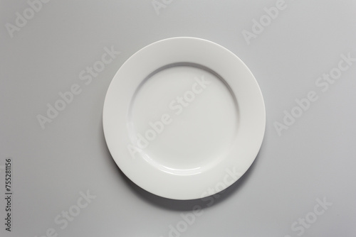 Empty white ceramic plate On a white gray background top view