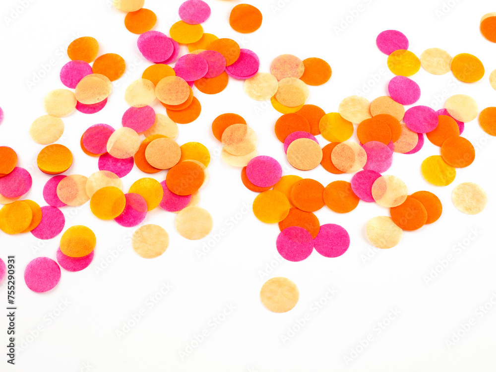 Close view of bright pink, orange and peach confetti on white background