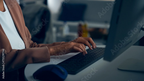 Black woman working with desktop computer in office. photo