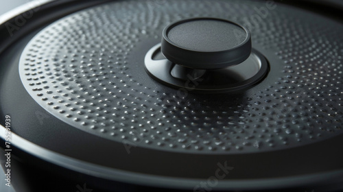 A closeup of the electric skillets domed lid with a steam vent showcasing its sleek modern design.
