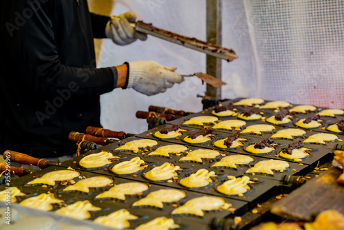 Japanese casual street food snack. Taiyaki. Red bean paste filling. a fish shaped pancake filled with bean jam. photo