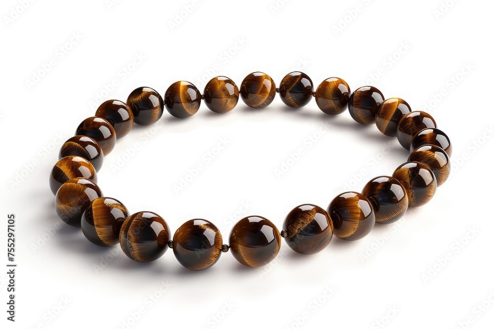 Chain of tiger eye pearls. Elegant luxurious necklace on white background. Beautiful present for every woman. Chain of tiger eye pearls. Elegant luxurious necklace on white background. Beautiful present for every woman.