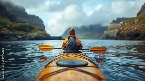 Backward view of traveler kayaking in the ocean. © tong2530