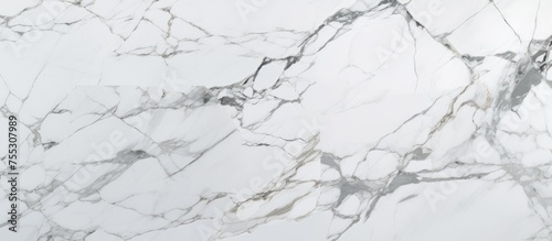 Detail shot of a white marble surface with a polished finish. The Italian Statuario marble features a glossy texture with subtle brown streaks running across the stone.