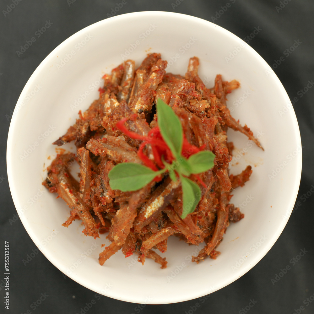 Sambal balado teri is fried anchovy with hot and spicy chili sauce.Traditional Indonesian food. Close-up.
Sambal balado teri is fried anchovy with hot and spicy chili sauce.Traditional Indonesian food. Close-up.