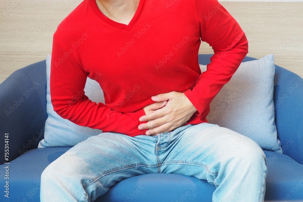Man having stomach ache after eating unhygienic food Human health and sickness concept