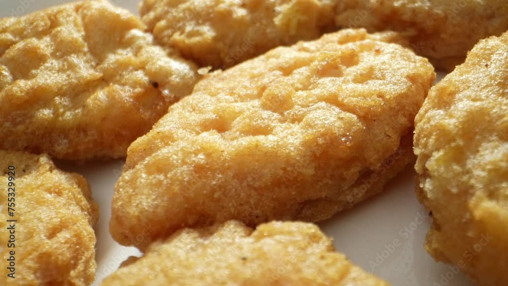Chicken nuggets are bite-sized pieces of chicken meat coated in breadcrumbs and deep-fried until crispy. They are a popular fast food item and can be served as a snack or part of a meal. Food concept. Chicken nuggets are bite-sized pieces of chicken meat coated in breadcrumbs and deep-fried until crispy. They are a popular fast food item and can be served as a snack or part of a meal. Food concept.