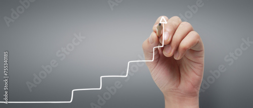 Male hand drawing graph chart showing business profit