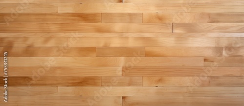 A detailed view of the intricate patterns and grains of a hardwood maple basketball court floor seen from a close distance.
