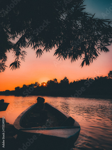 boat stranded on the river during sunset photo