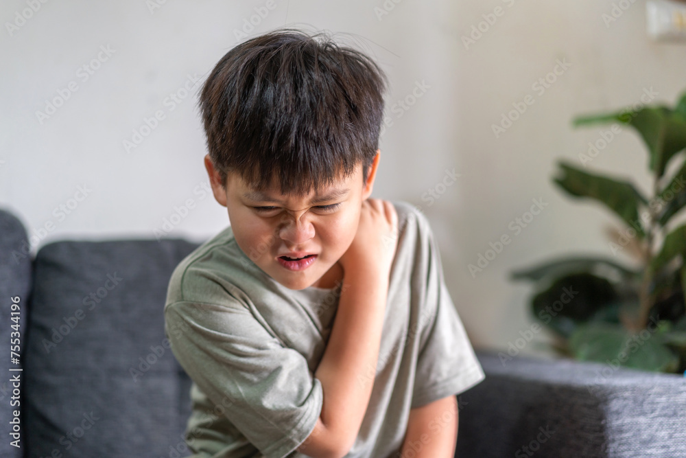 Child experiencing back pain, subtly conveying themes of health, discomfort, and the need for care in childhood, lower back with a pained expression, health and wellness, children's physical health
