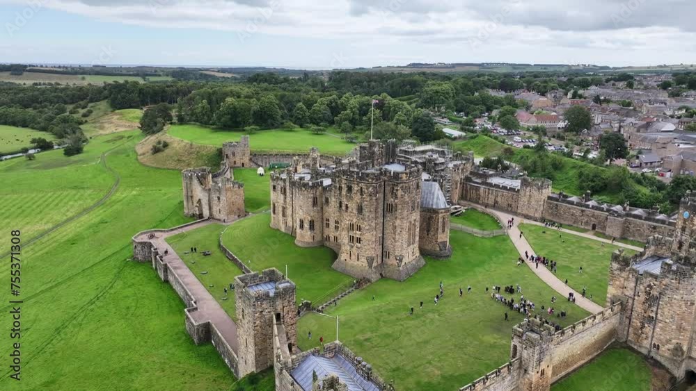 Medieval Alnwick Castle, England UK. Aerial View of Landmark, Walls and Green Landscape, Drone Shot 60fps
