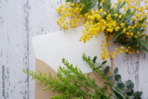 International women's day concept beautiful mimosa flower composition with blank greeting card. beautiful floral background for Women's day. photo