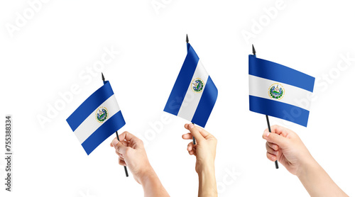 A group of people are holding small flags of El Salvador and Tobago in their hands. photo