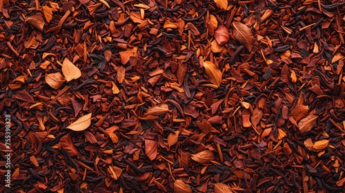 Closeup texture of dried red rooibos tea leaves.