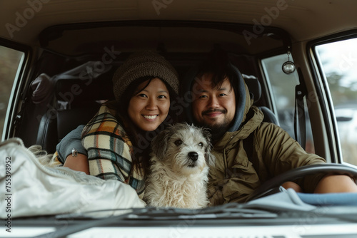 Couple Sitting in Back Seat of Car with White Dog, Enjoying a Relaxing Drive Together