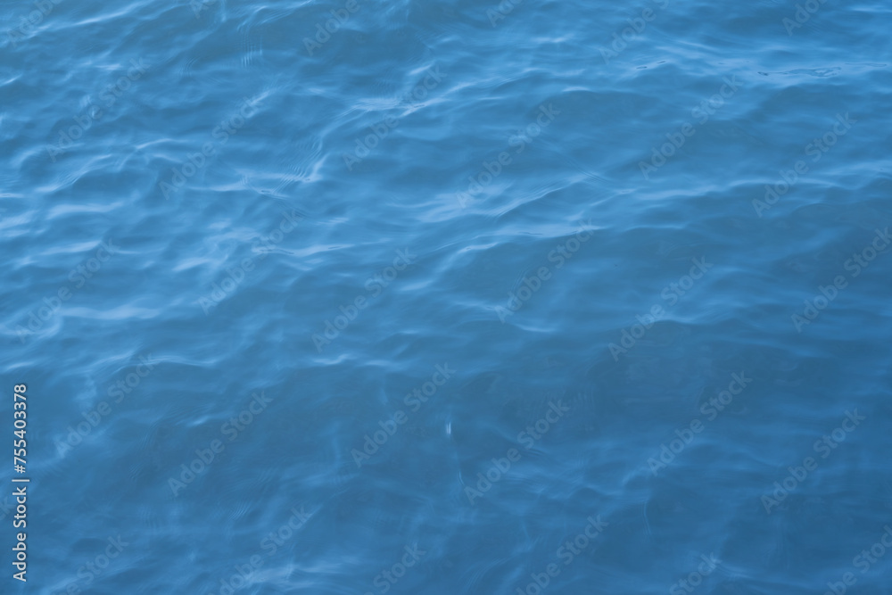 Blue sea water background. Texture of the water surface with ripples