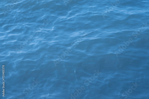 Blue sea water background. Texture of the water surface with ripples